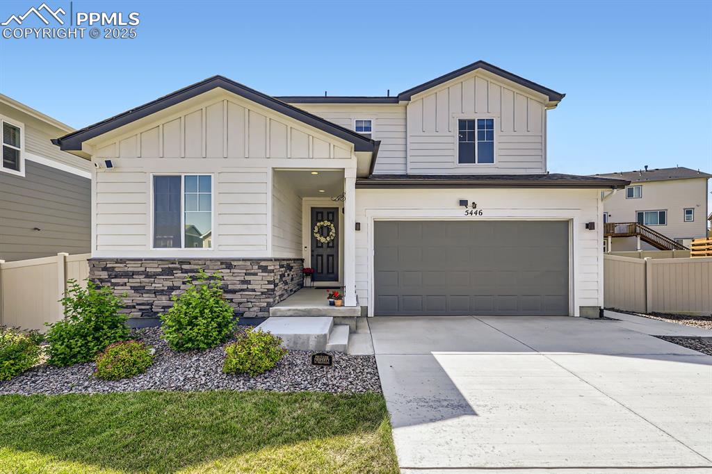 Image 2 of 28: View of front of property featuring board and batten siding, an attached ga