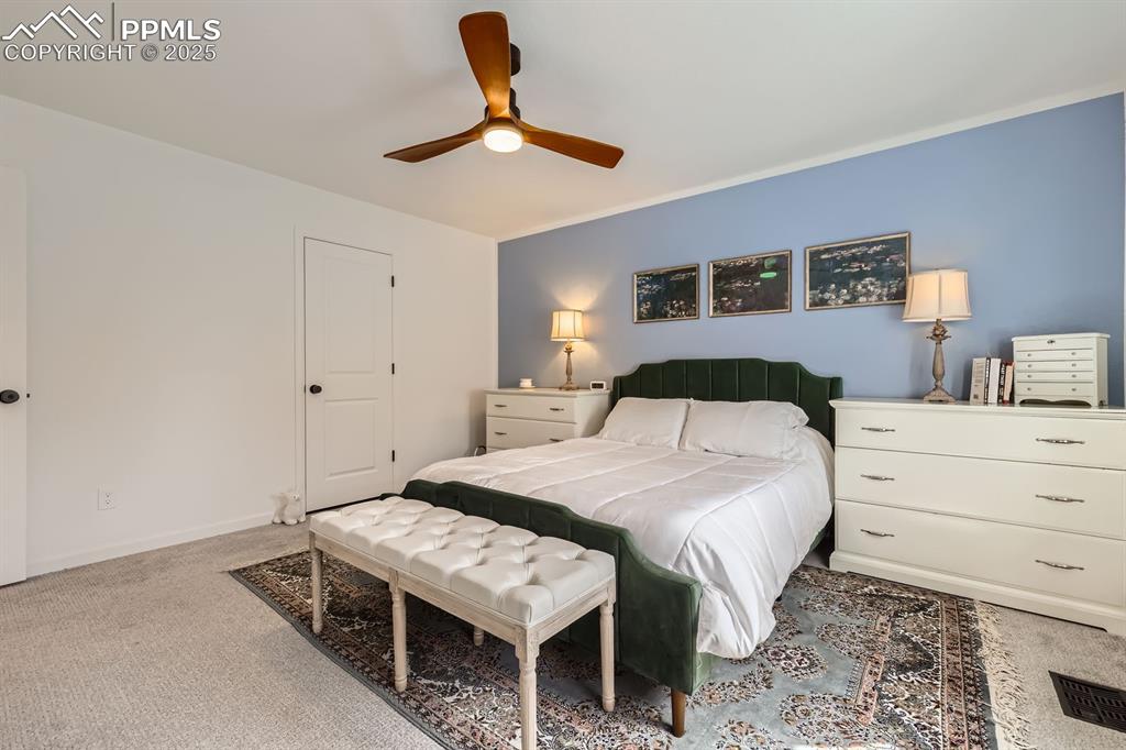 Image 20 of 28: Carpeted bedroom with ceiling fan and baseboards