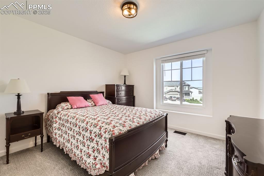 Image 26 of 28: Bedroom with carpet flooring and baseboards