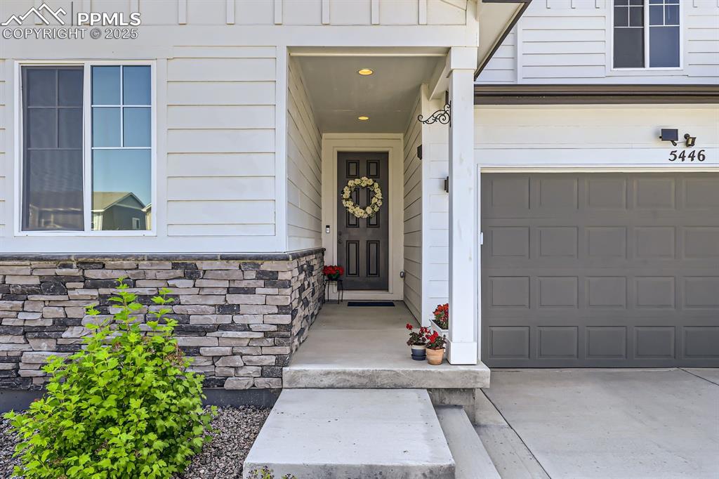Image 6 of 28: Property entrance with a garage