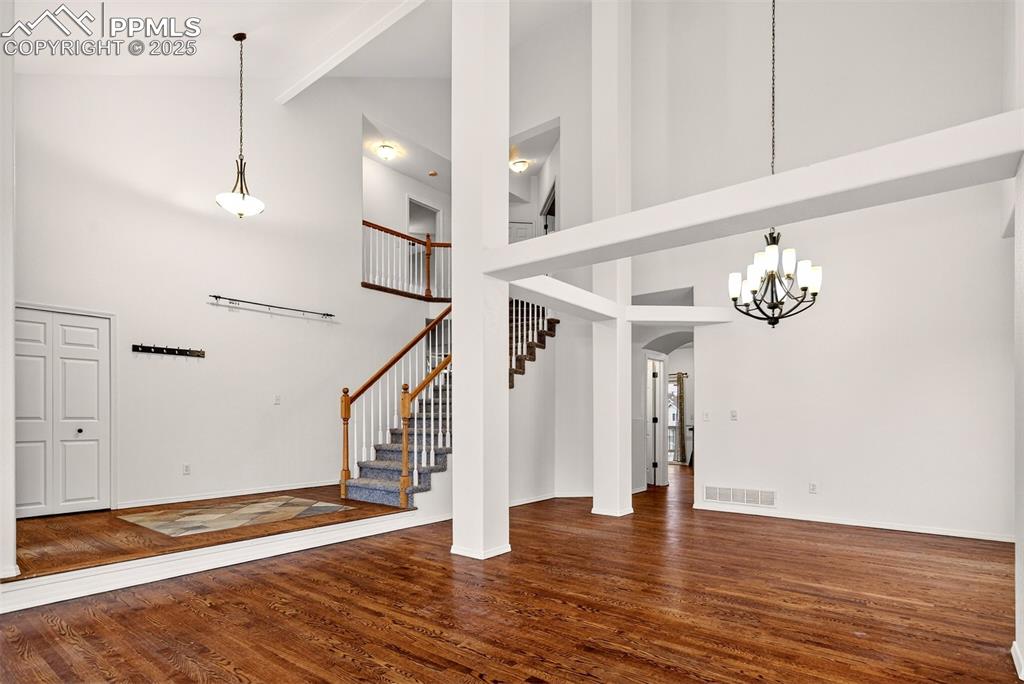 Image 7 of 49: Exquisite Formal Living & Dining Room with Vaulted Ceiling