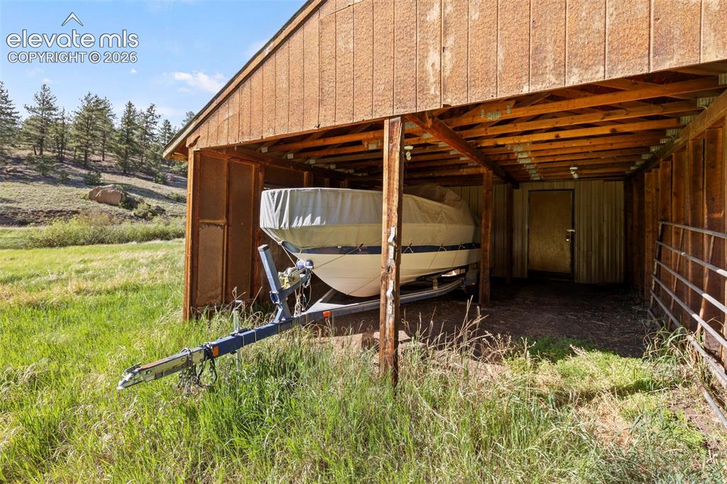Image 38 of 50: Large barn and storage area. 
