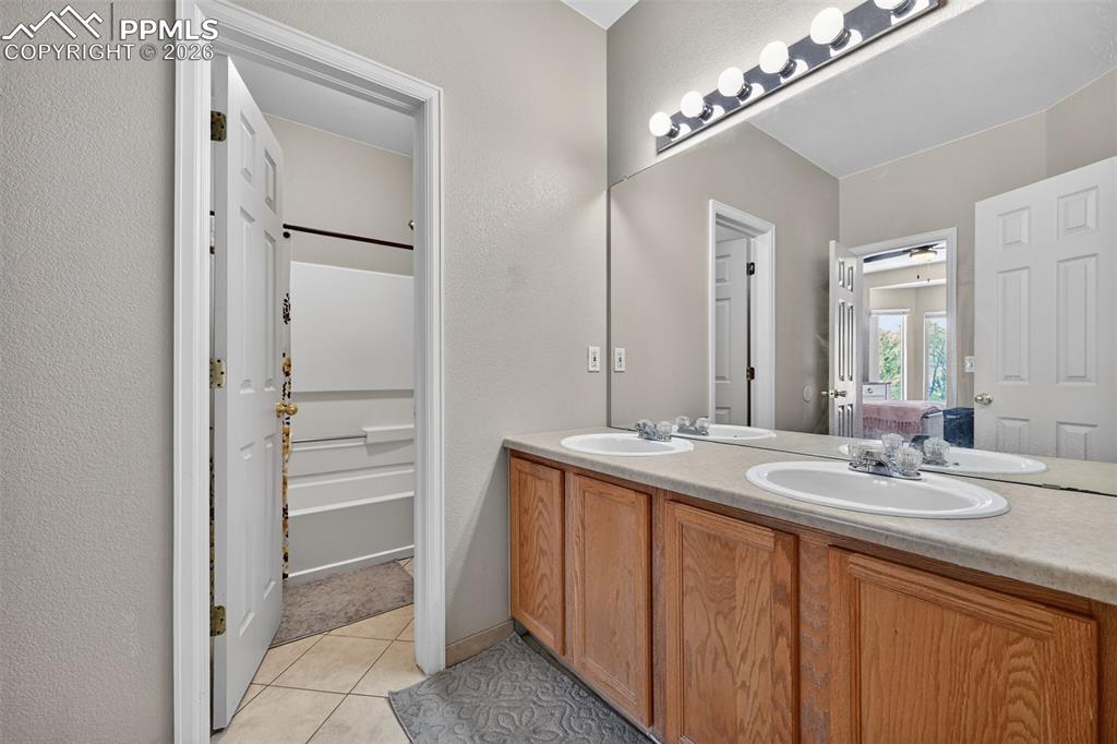 Image 13 of 21: Upstairs bathroom with double vanity