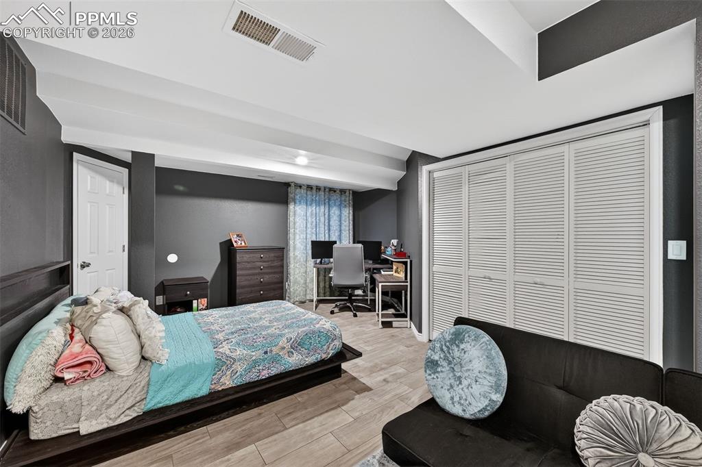 Image 16 of 21: Basement living space. Could be a separate bedroom area with attached bathr