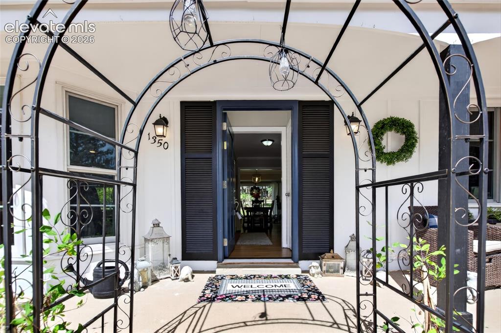Caption: Arched wrought iron entryway with integrated pendant lighting