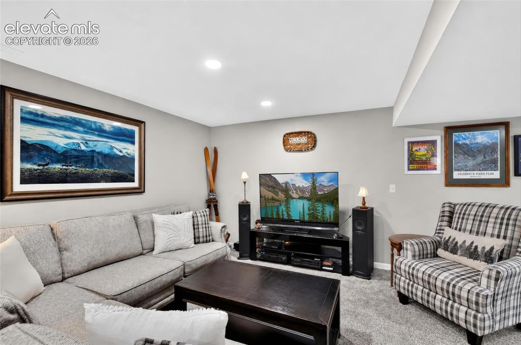 Image 20 of 43: Recessed lighting illuminates a spacious room featuring wall-to-wall carpet