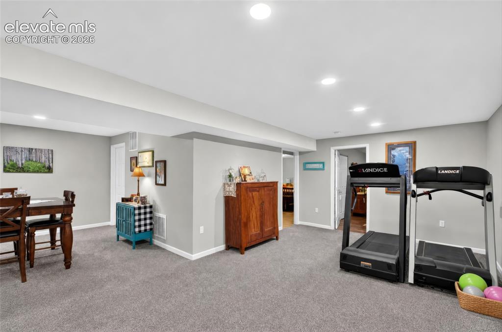 Image 22 of 43: Recessed ceiling lighting, light gray wall paint, and gray carpet flooring