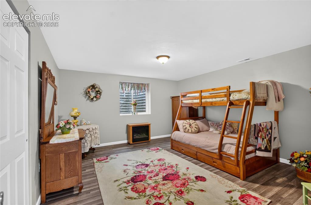 Image 23 of 43: Wood-finish flooring, light gray walls, and a recessed window with blinds