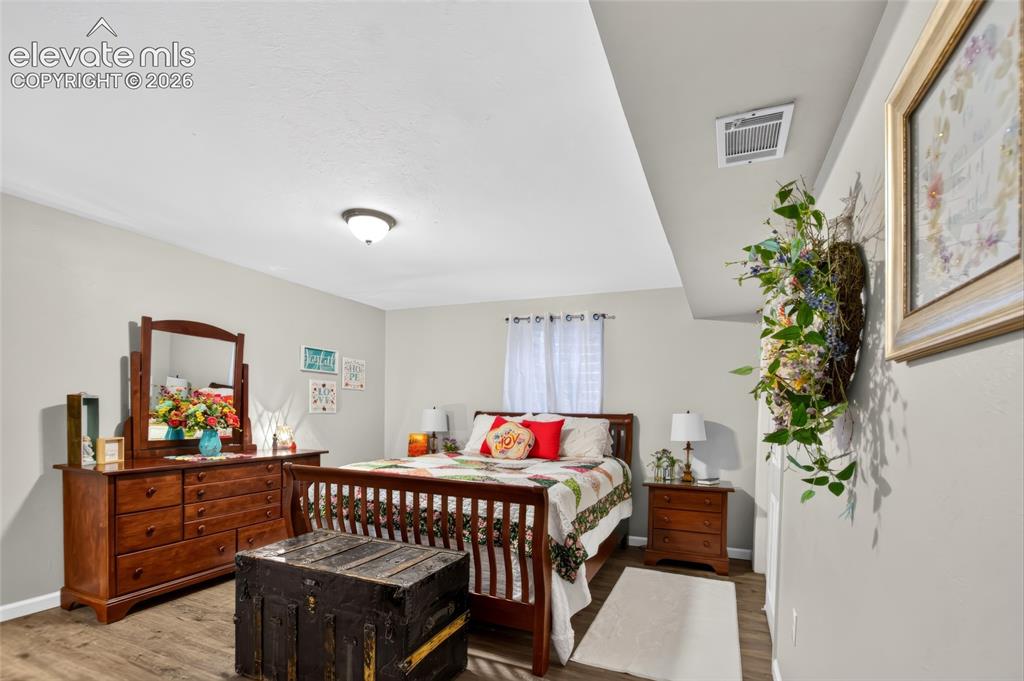 Image 24 of 43: Recessed ceiling, wood-finish flooring, light-toned walls, and a window wit