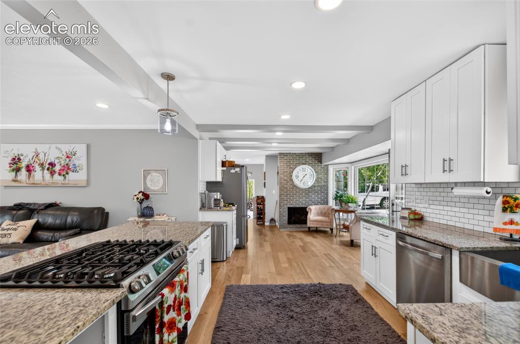Image 4 of 43: Gourmet kitchen with granite countertops, white shaker cabinetry, stainless