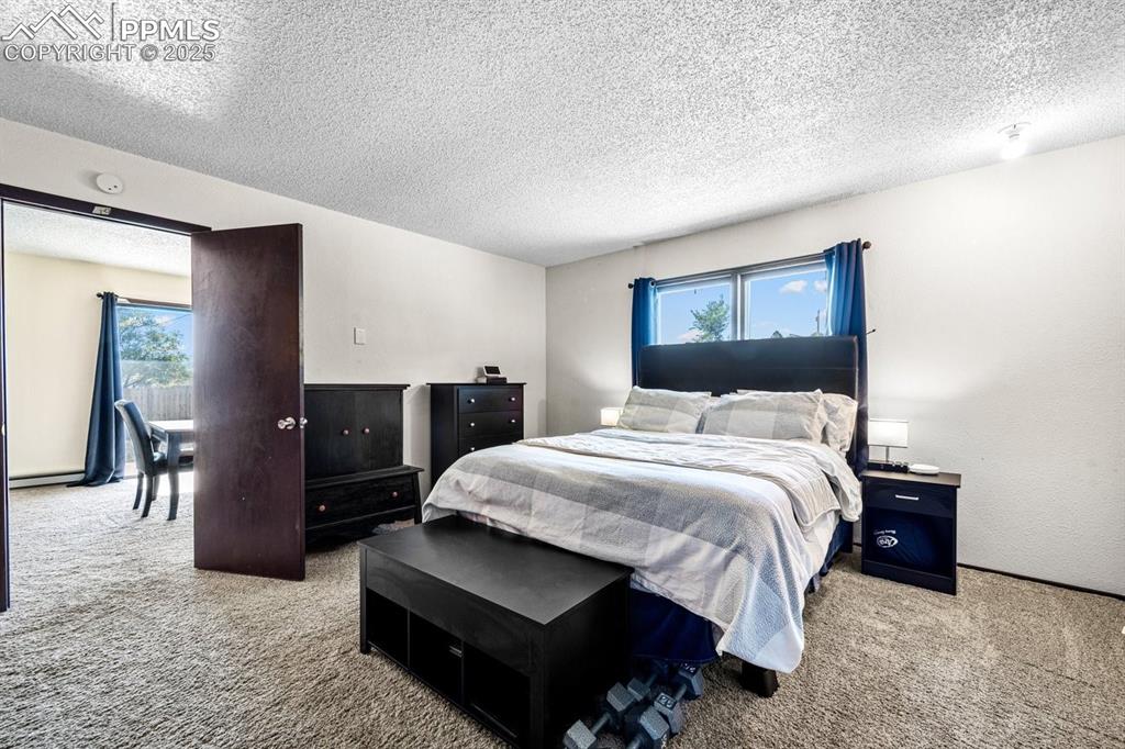 Image 16 of 38: Carpeted bedroom featuring a textured ceiling