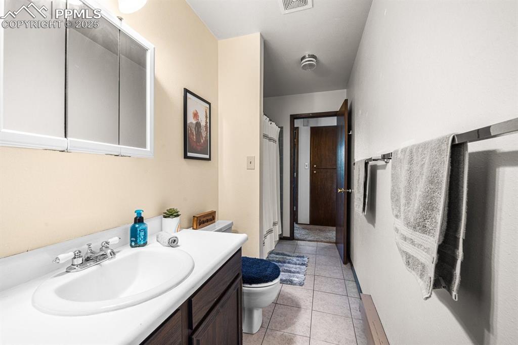 Image 18 of 38: Bathroom featuring light tile patterned floors and vanity
