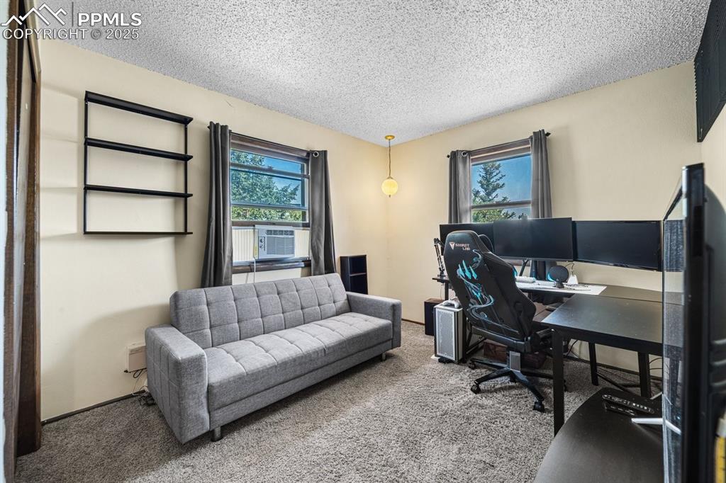 Image 24 of 38: Carpeted office space with a textured ceiling