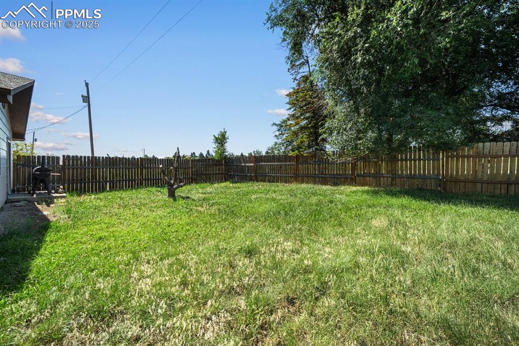 Image 28 of 38: View of fenced backyard