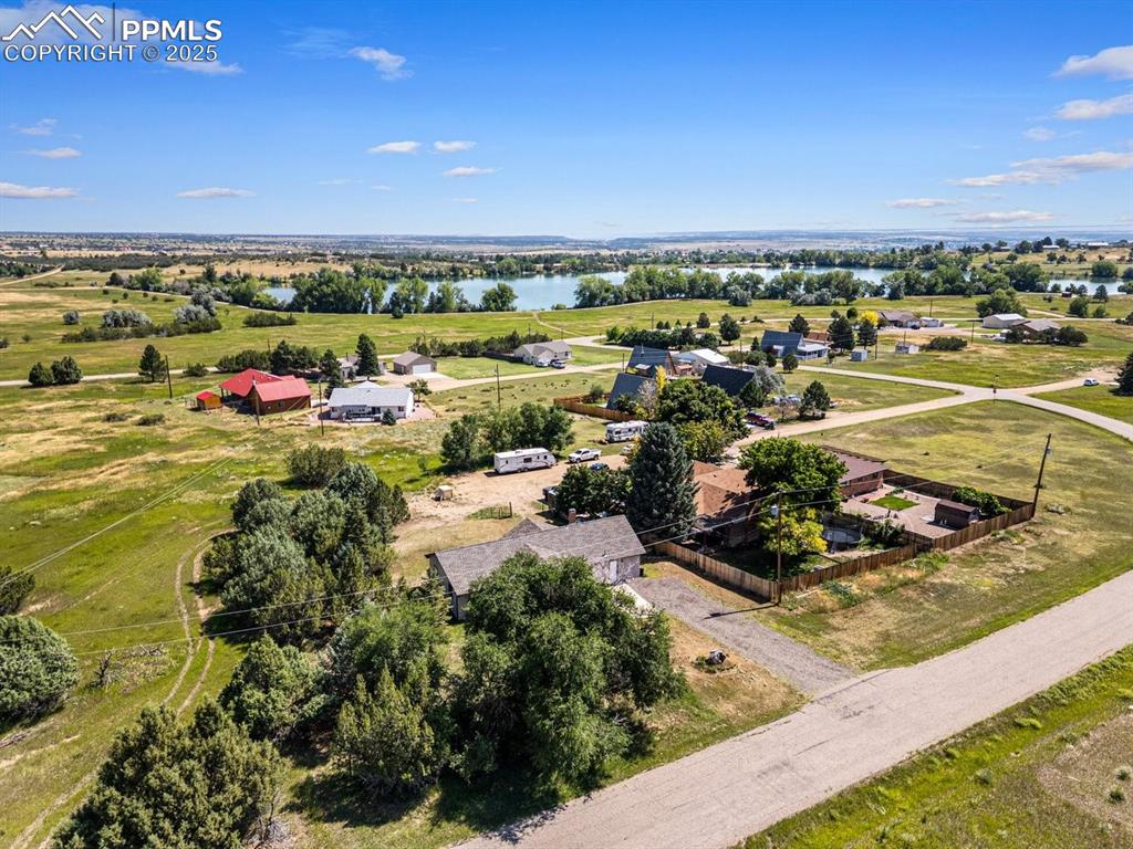 Image 38 of 38: Aerial view of sparsely populated area with a large body of water