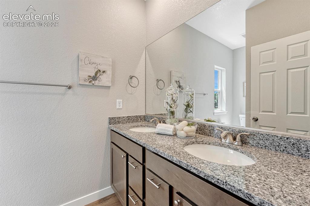 Image 11 of 28: En suite primary bathroom offers double vanity with undermount sinks. Pick 