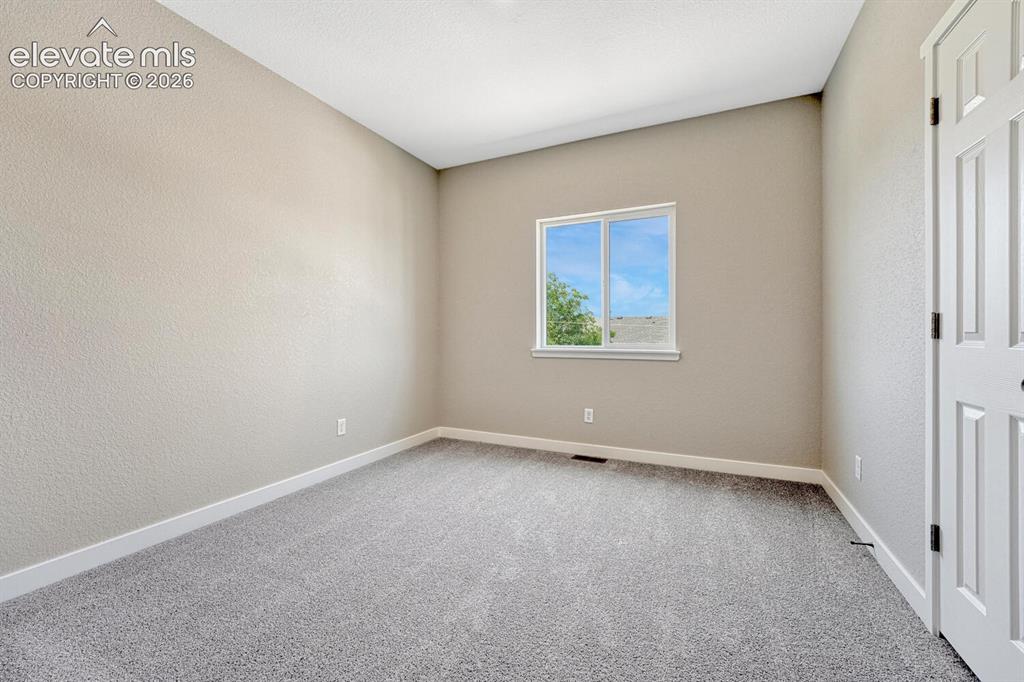 Image 13 of 28: Two secondary bedrooms on upper level.