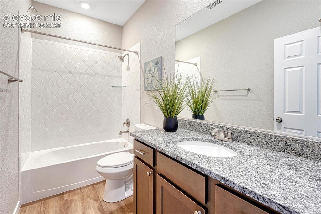 Image 17 of 28: A full bathroom serves the secondary bedrooms. Your choice of finishes with