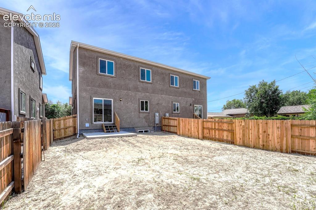 Image 20 of 28: Sizable backyard is fully fenced for privacy and pets.