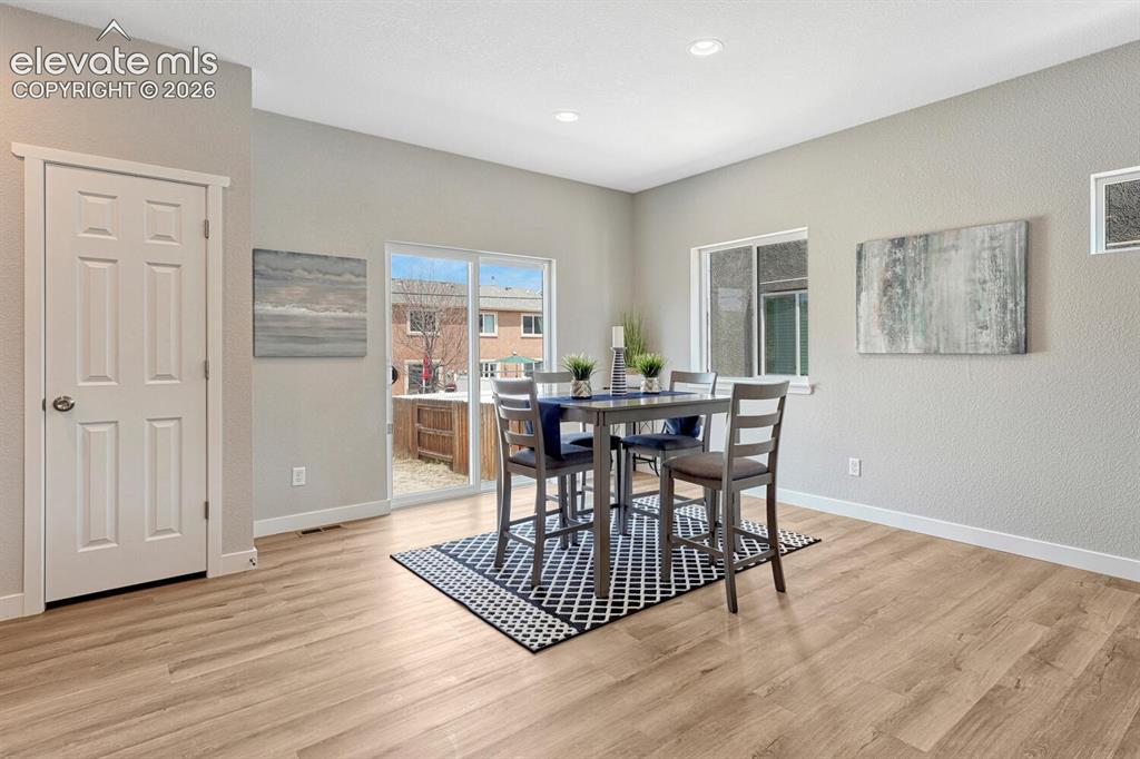 Image 7 of 28: Dining area walks out to fully fenced backyard. Seamlessly move gatherings 