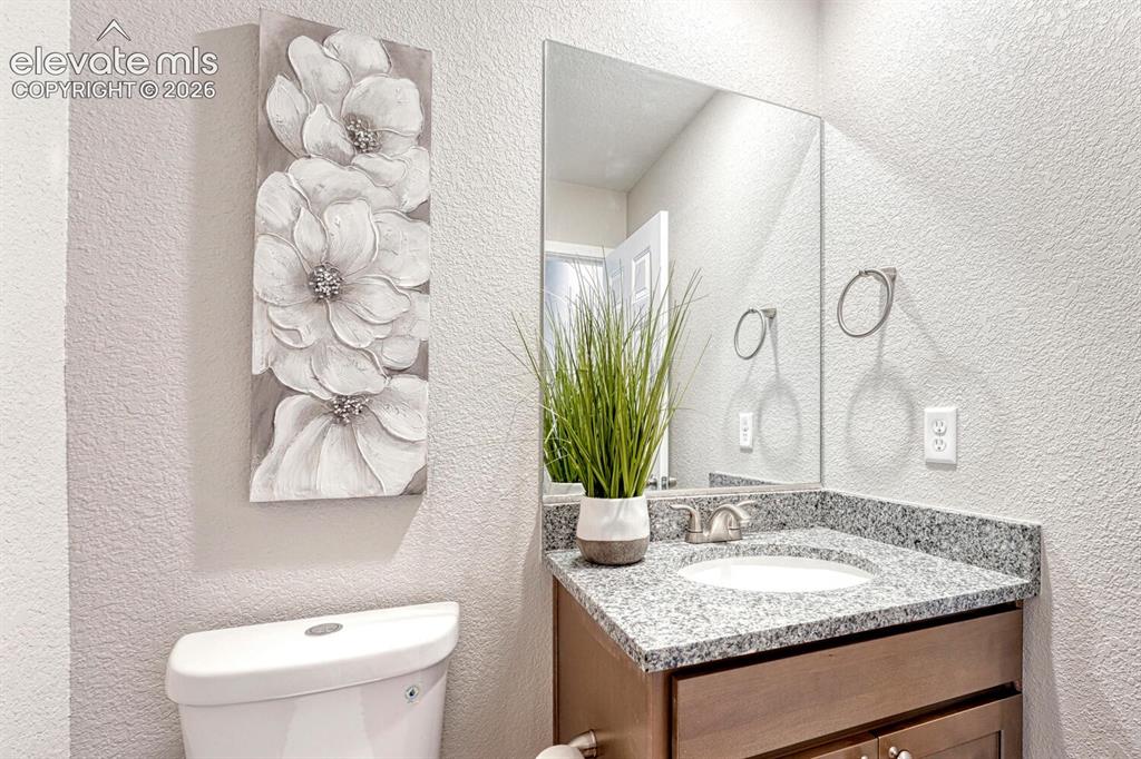 Image 8 of 28: Half bath with your choice of cabinetry and countertop is on the main level