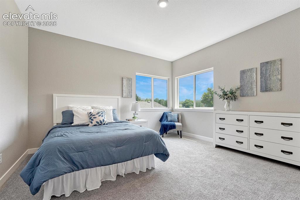 Image 9 of 28: 9 ft ceilings on the upper level. Primary bedroom glows with natural light.