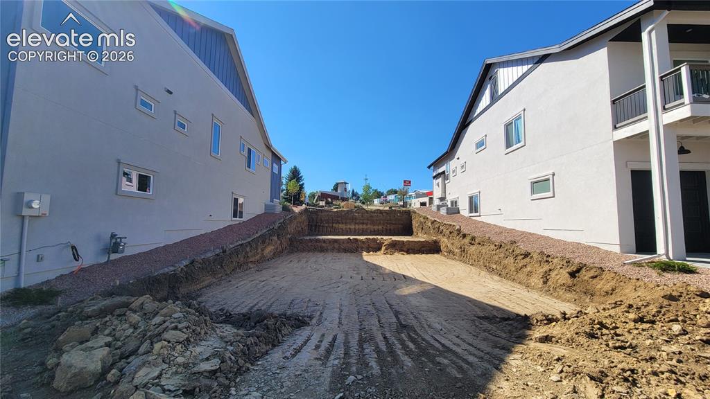 Image 4 of 6: 2 Car Tuck Under Garage at Paved Alley! Please, excuse our dust as this hom
