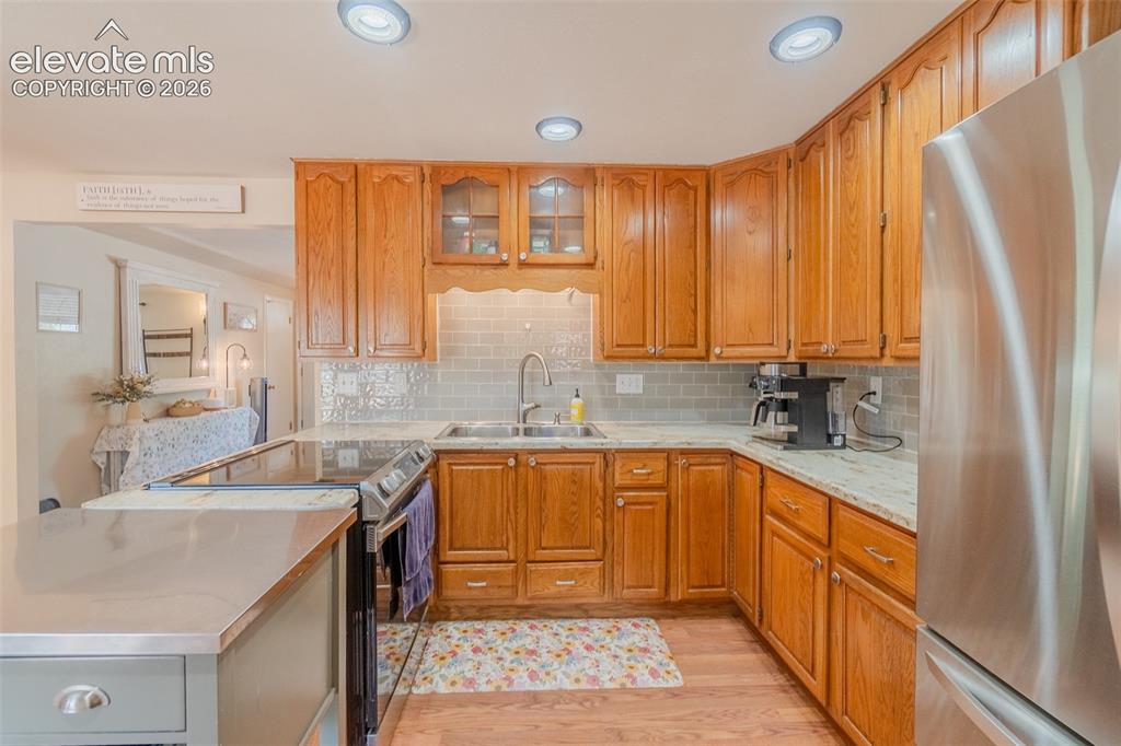Image 13 of 46: Spacious living area featuring wood-finish flooring, recessed lighting, and