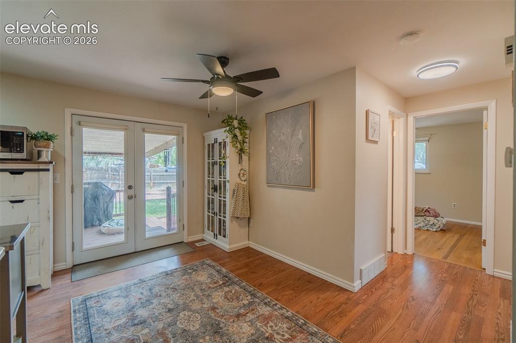 Image 17 of 46: Kitchen featuring wood-finish flooring, recessed lighting, wood cabinetry,