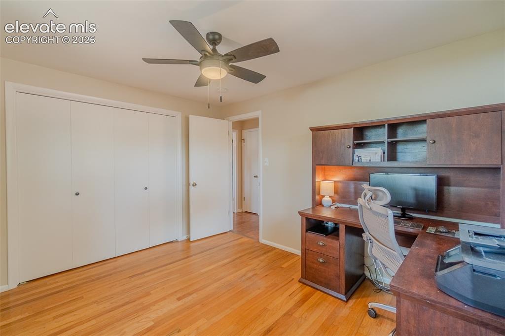 Image 20 of 46: Bright room featuring wood-finish flooring, two windows with white trim, a