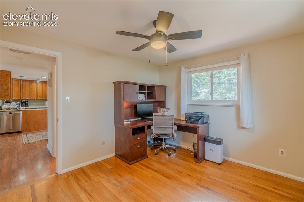 Image 21 of 46: Hardwood flooring throughout the room features a light finish