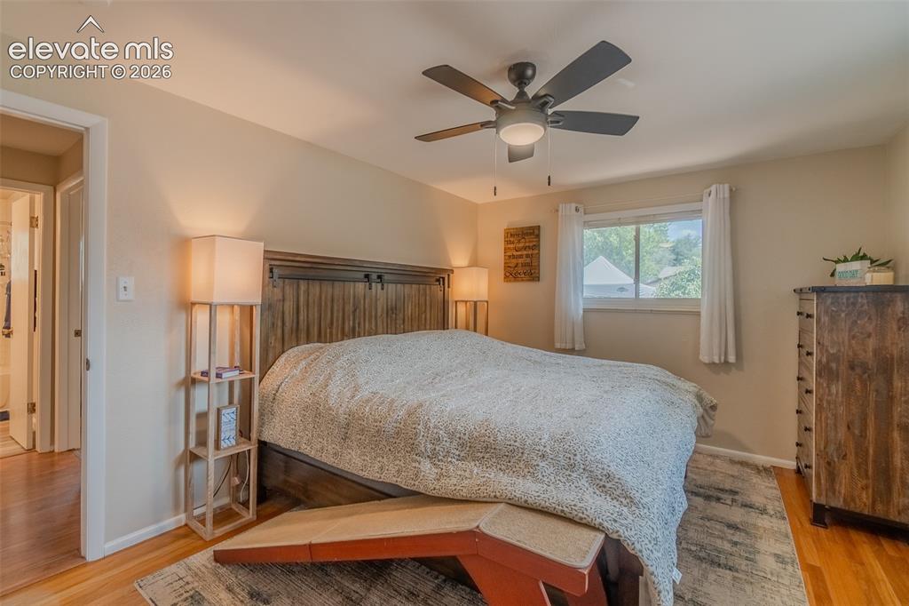 Image 22 of 46: Light-filled room featuring wood-finish flooring, a ceiling fan with integr