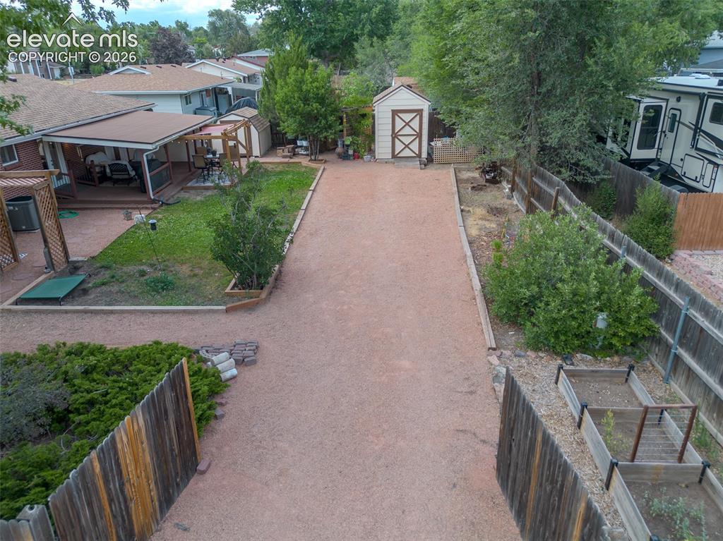 Image 3 of 46: Expansive backyard featuring a covered patio, additional wood pergola, two