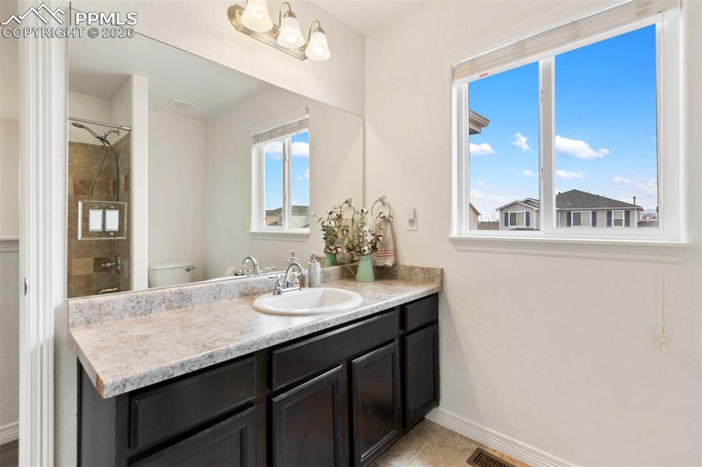 Image 25 of 34: Clean bathroom with bright, fresh feel