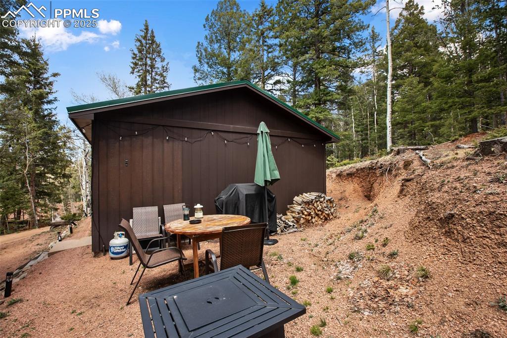 Image 33 of 49: View of outdoor structure with outdoor dining space