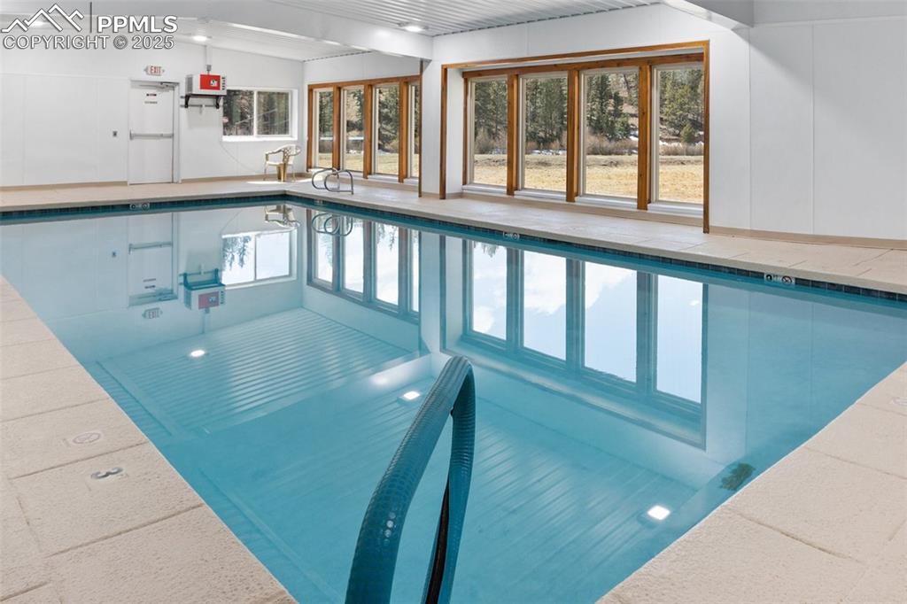 Image 36 of 49: Indoor community pool featuring a sink