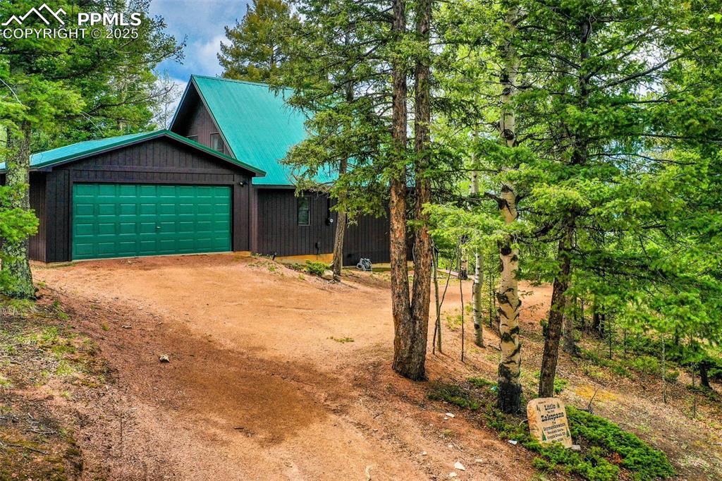Image 47 of 49: Chalet / cabin featuring driveway and an attached garage