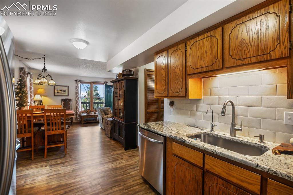 Image 6 of 49: Kitchen featuring stainless steel appliances, and granite countertops