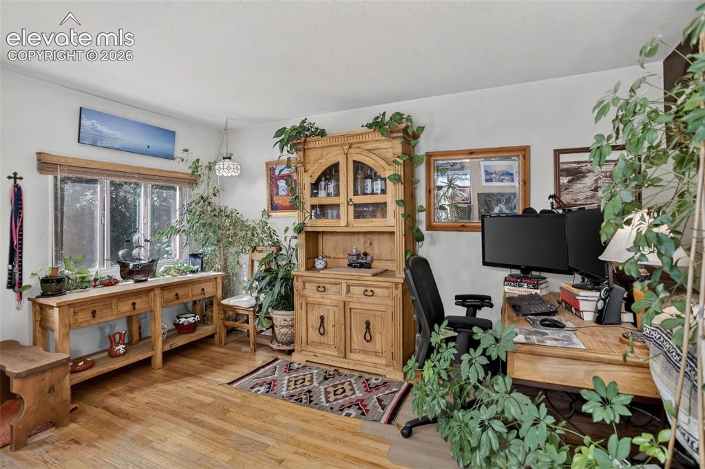 Image 13 of 25: Wood-finish flooring with abundant natural light from a multi-pane window