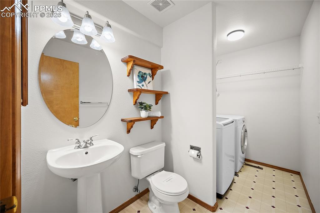 Image 17 of 44: Main level 1/2 bath and laundry combo. 