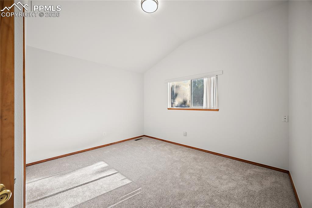 Image 25 of 44: Upstairs bedroom 3, vaulted ceilings and new carpet. 