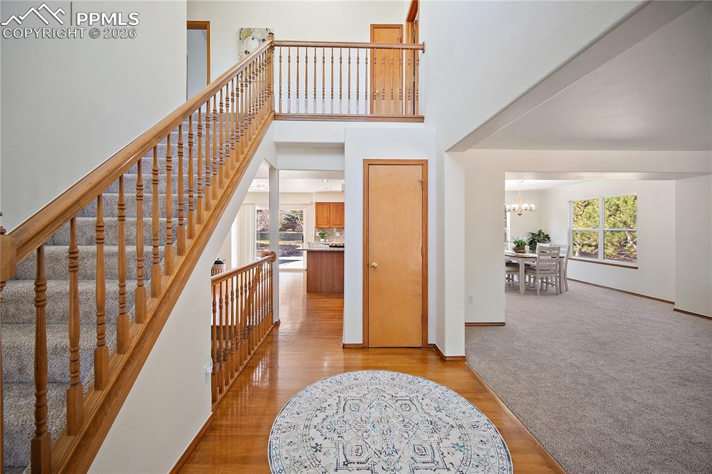 Image 4 of 44: Front entry with hardwood flooring