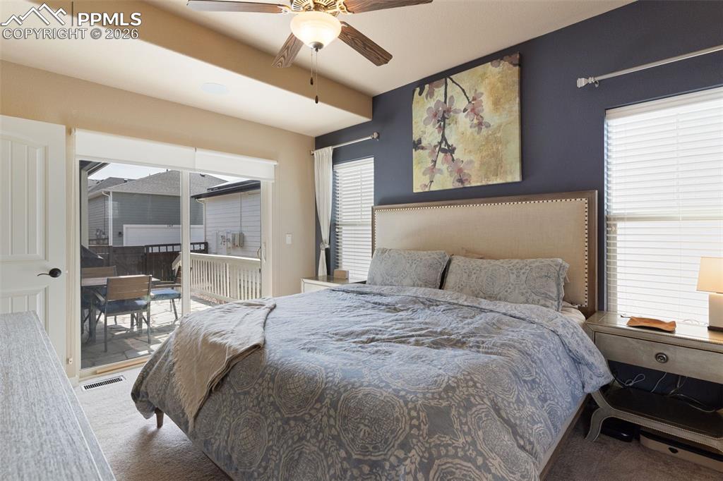 Image 17 of 45: Main level primary suite with walk-out to the patio