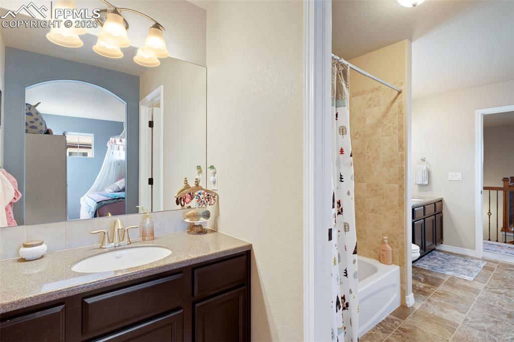 Image 26 of 45: Vanity/sink in the bedroom pictured before, with adjoining full bathroom