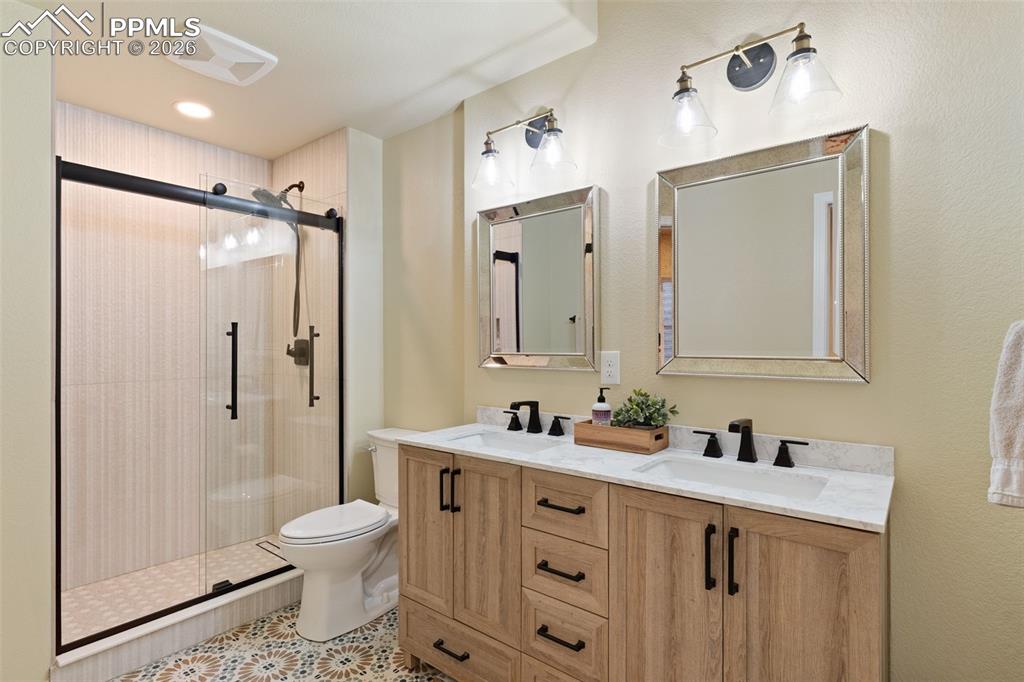 Image 34 of 45: Beautiful bathroom with custom tiled walk-in shower in the basement