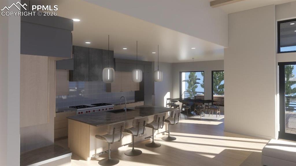 Image 10 of 45: Kitchen featuring range, modern cabinets, a sink, a breakfast bar area, and