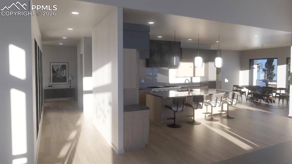 Image 11 of 45: Kitchen featuring modern cabinets, light wood finished floors, and a kitche