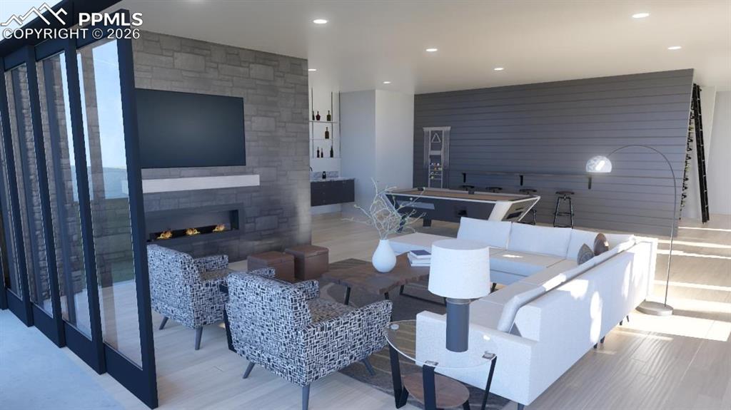 Image 23 of 45: Lower level patio with stone linear gas fireplace