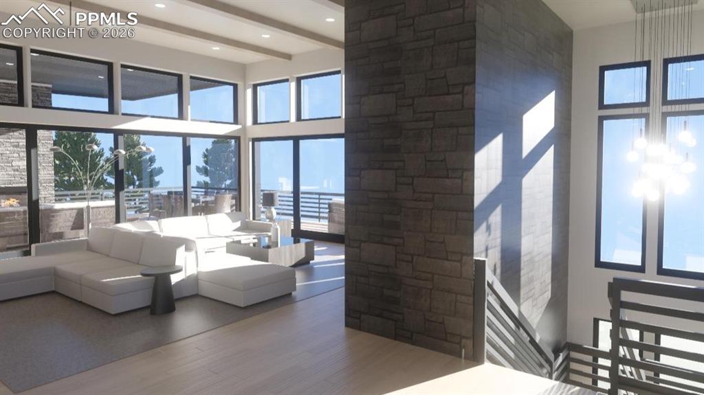 Image 3 of 45: Living area featuring a high ceiling, wood finished floors, and ceiling bea