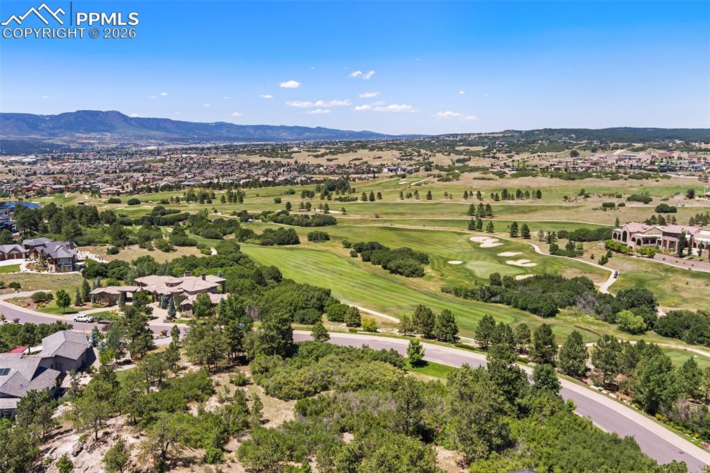 Image 39 of 45: Birds eye view of property with golf course view and a mountain view